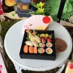 iaada international fairy's sushi in a black bento box and pink fan